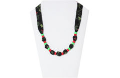 Christmas necklace with black cotton ties and green and red pony beads.