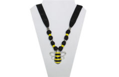 A fun bumblebee necklace on black cotton fabric with metal bumblebee for pendant