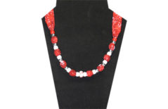 A Christmas necklace with red cotton fabric and red and white beads
