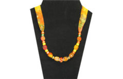 Bright orange and yellow cotton necklace with pony beads and center glass bead