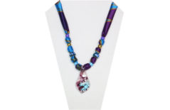 Fun necklace with purple and blue multi-color silky fabric and a glass pendant sporting a blue tree frog.