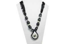 Vintage necklace in black and white with lacy fabric and glass pendant