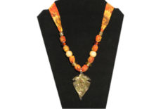 Fall theme necklace with sunflower printed fabric and glass leaf pendant