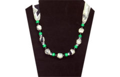A fun necklace with printed US currency on green and white fabric