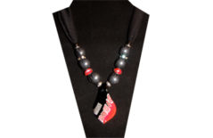 A sparkly black sheer fabric with a bright contemporary designed glass pendent of a red, black and silver pattern. The beads are red glass, clear rhinestone on silver tone metal and plain silver tone metal.